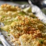 Panko encrusted roasted fennel on a white dish.