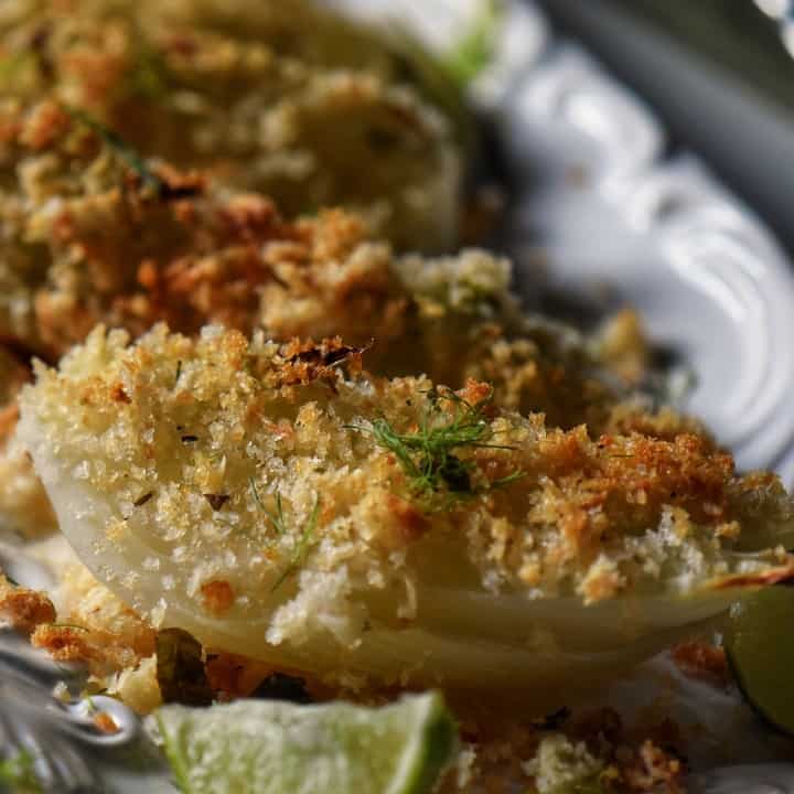 Oven baked fennel with a crispy garnish of Panko bread crumbs and fennel fronds.
