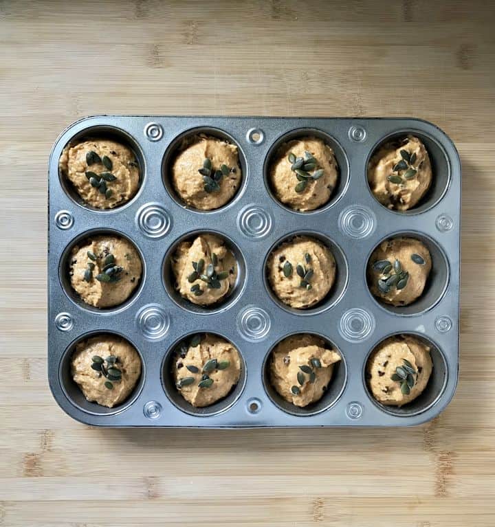 A tray of portioned muffins ready to be baked.