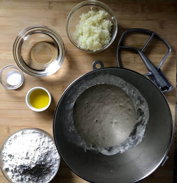 Some of the ingredients to make the focaccia bread dough in small bowls.