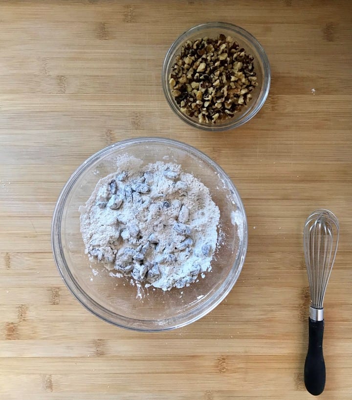 Dates and 1 tablespoon of flour are combined in a bowl.