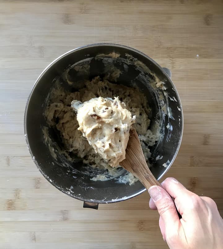 The cookie dough mixture on a large wooden spoon.