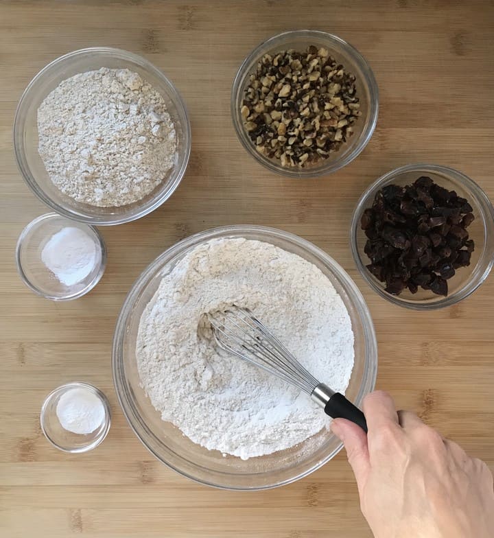 Ingredients to make crunchy oat cookies in individual bowls.