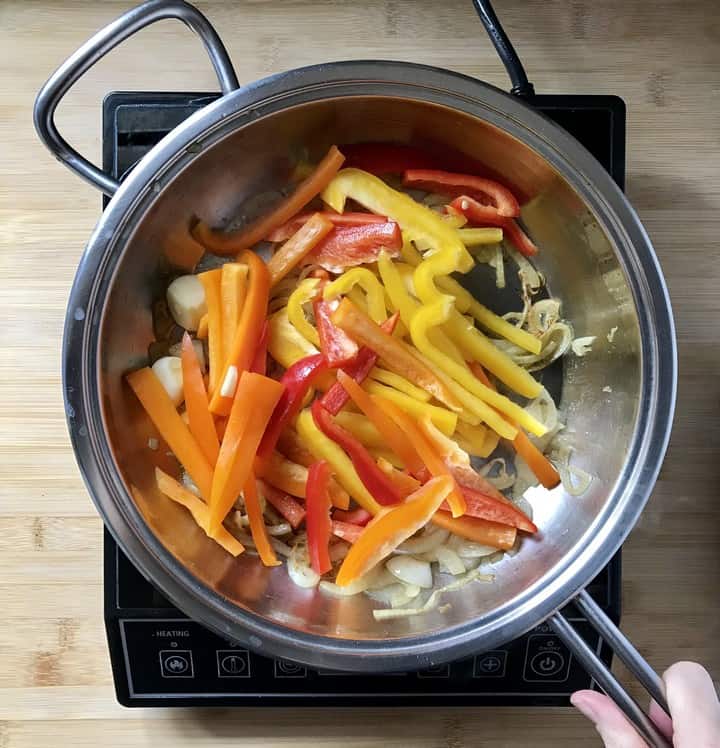 An assortment of bell peppers added to the frying pan to make the peperonata recipe.