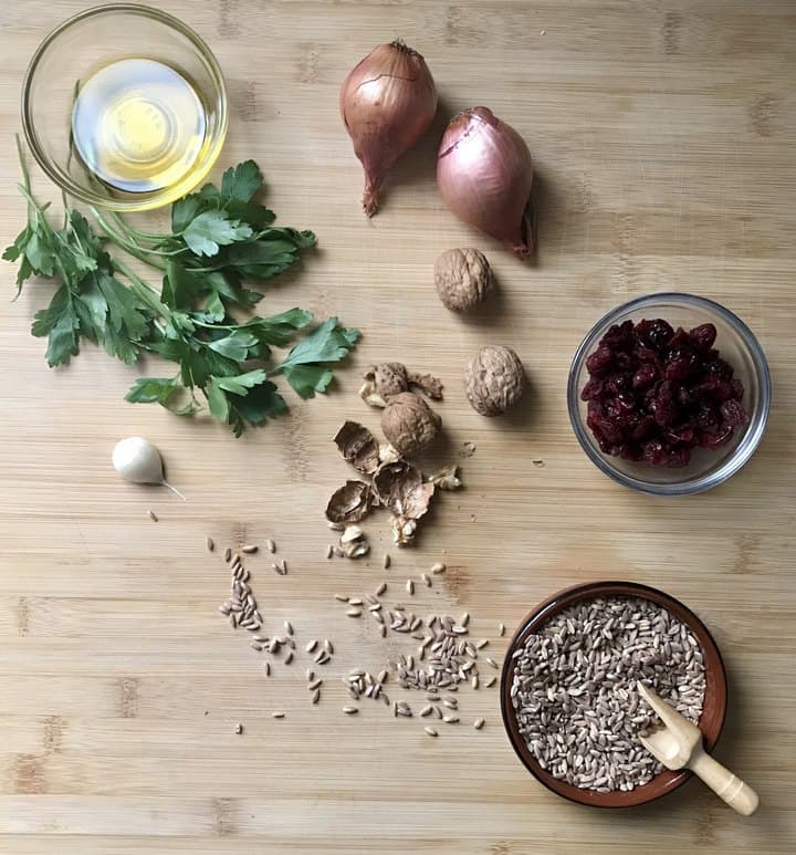 Some of the ingredients needed to make this Italian salad on a wooden board.