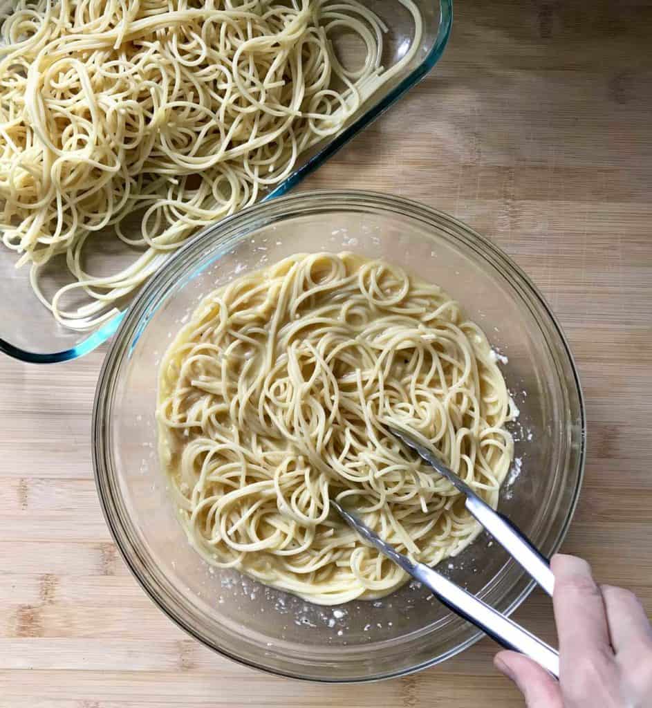 Cooked spaghetti is added to the egg mixture.