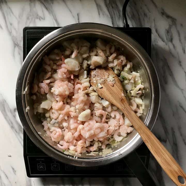 The mixture for Coquilles St-Jacques is being made in a saucepan.