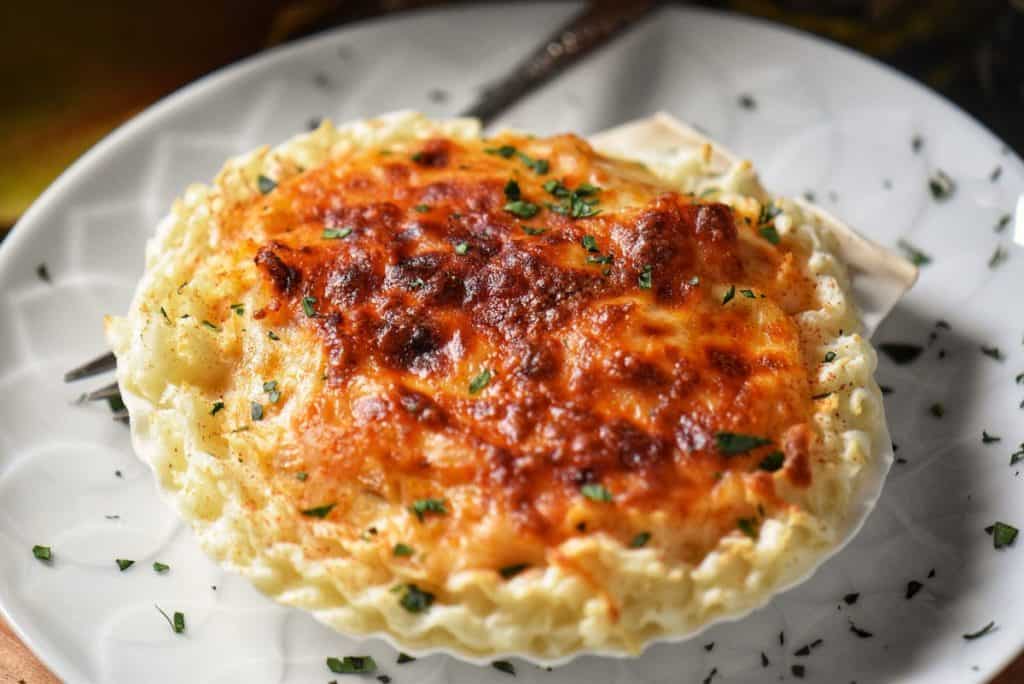 A golden cheesy crust of Coquilles St-Jacques.