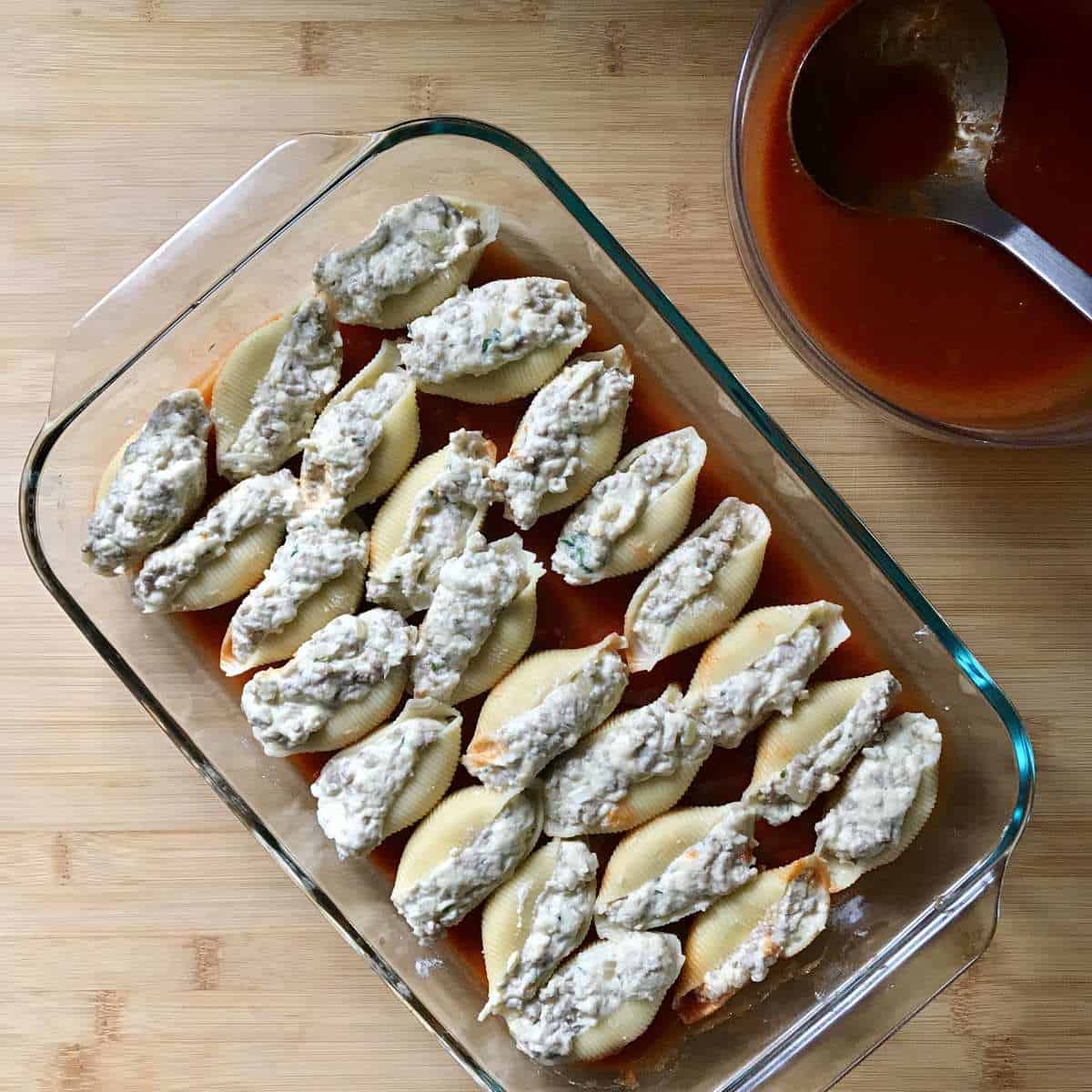 The filled pasta shells in a baking dish.