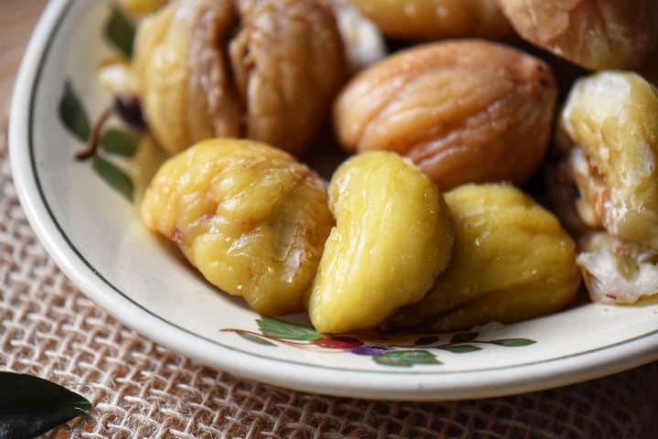 A few boiled chestnuts in a serving plate.