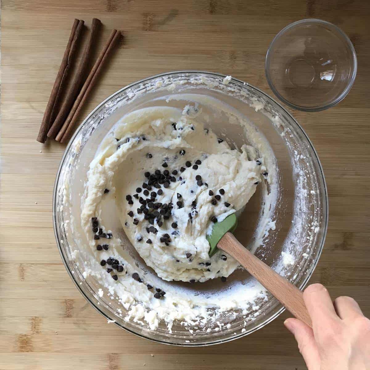 Chocolate chips are being folded in to the cannoli dip.