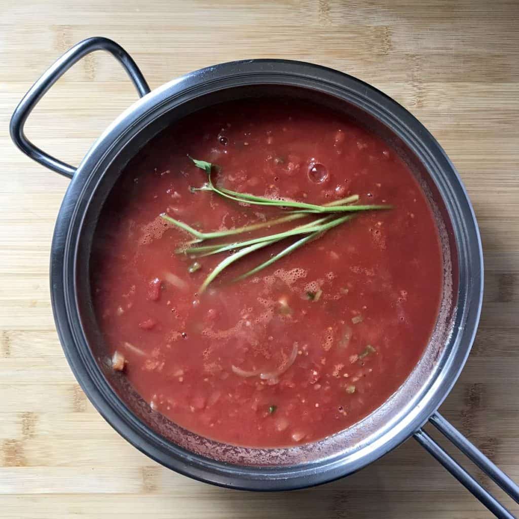 Parsley stalks added to the tomato sauce.