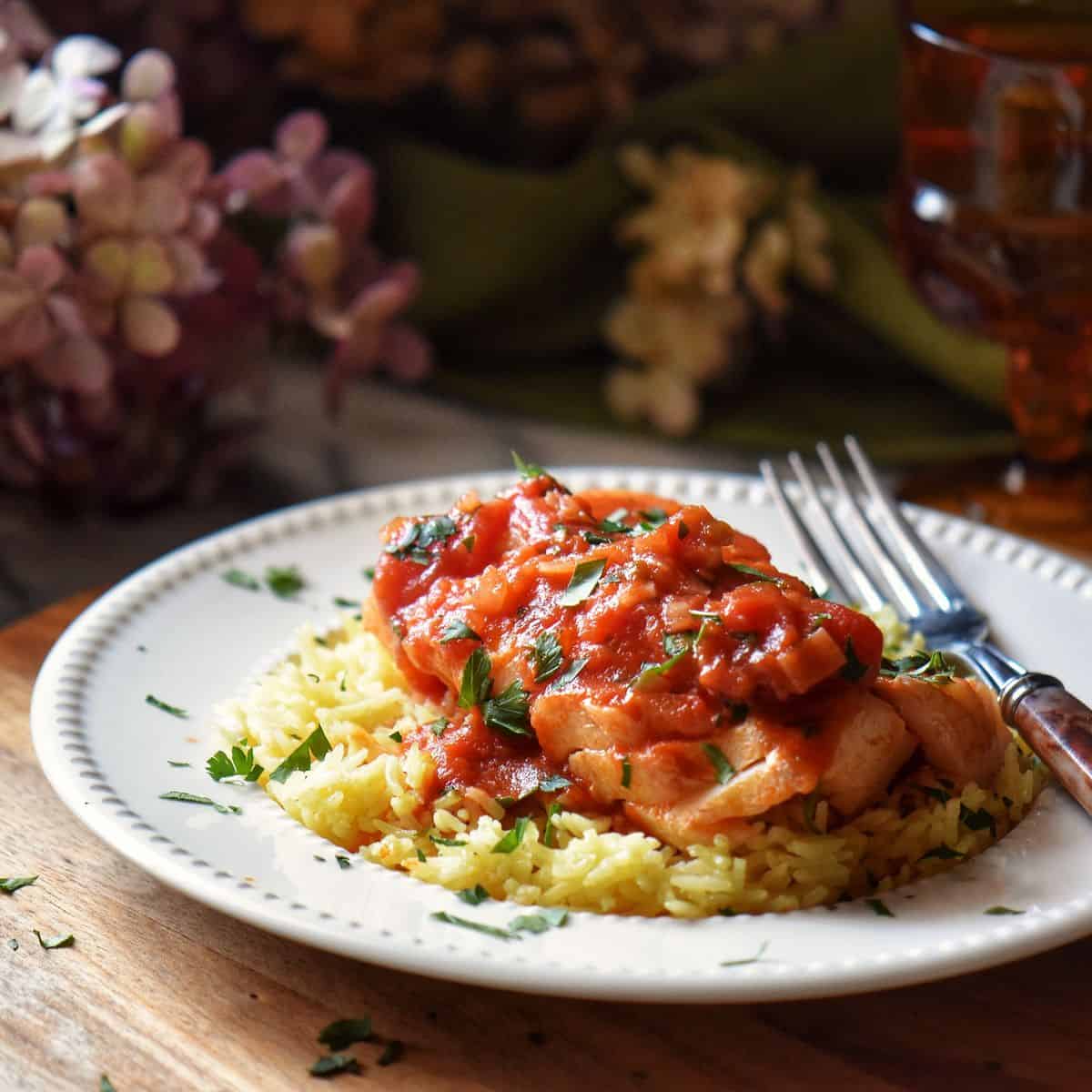 Italian cod with tomato sauce on a bed of rice.