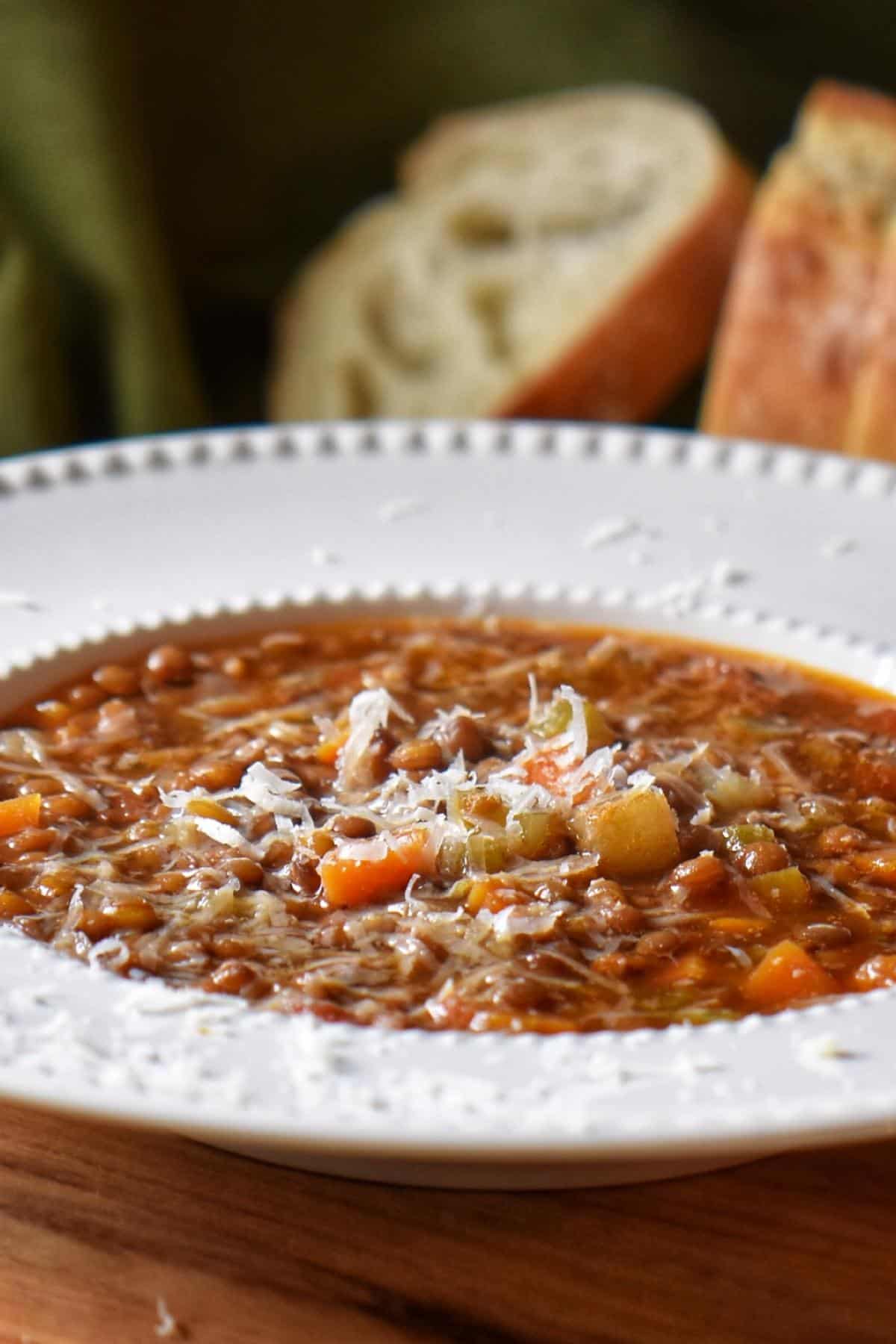 Close up of grated cheese on lentil soup.