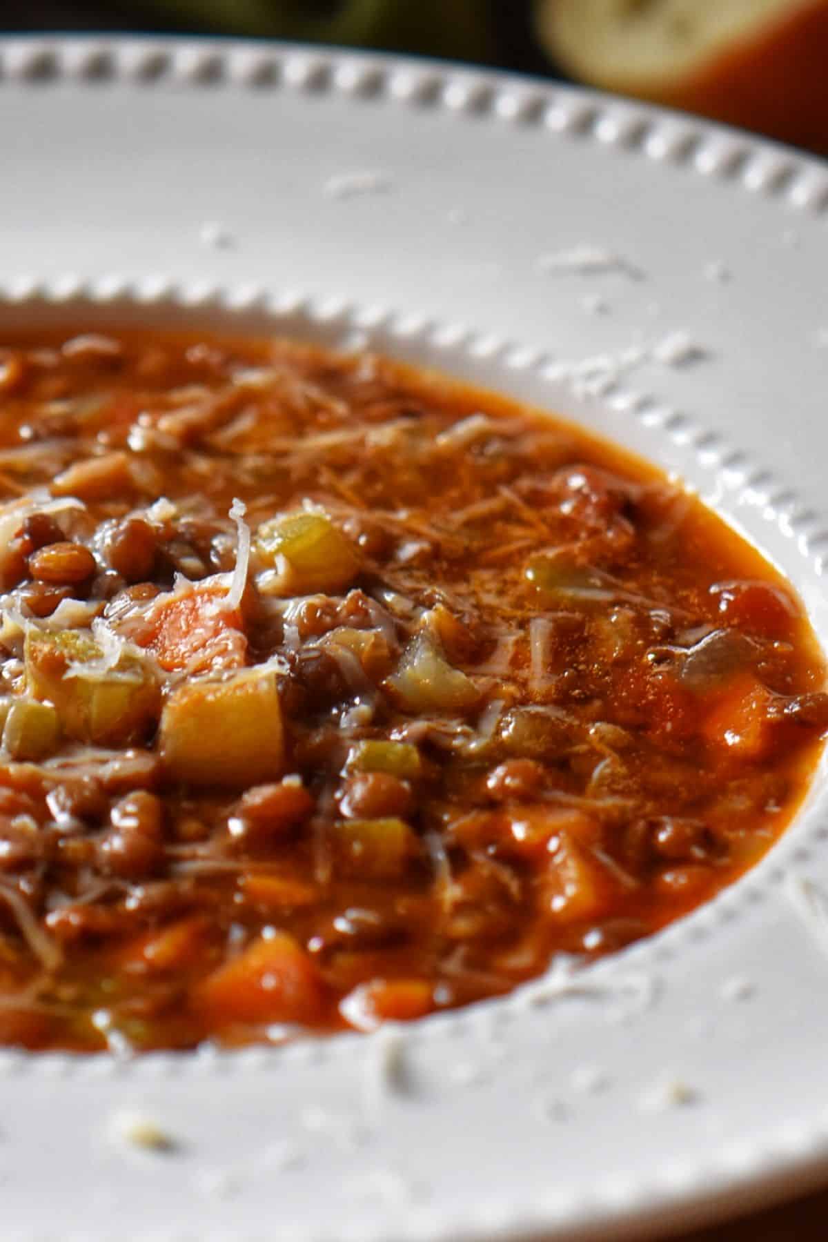 Lentil soup in a big white bowl.