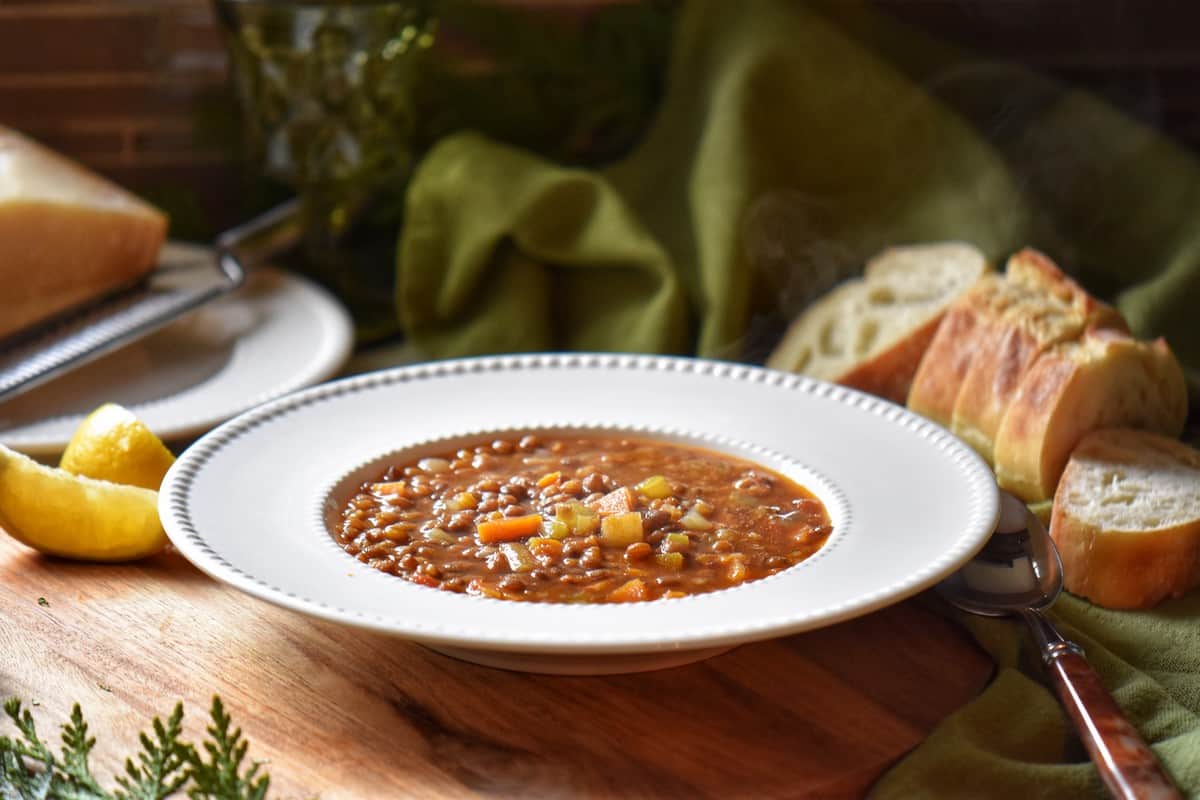 Lentil soup with vegetables in a white bowl.