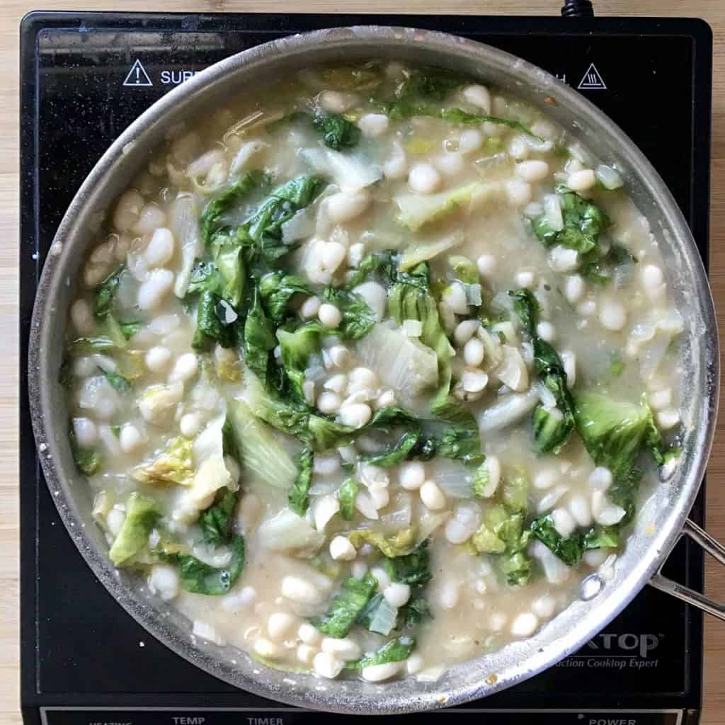 A simmering pot of escarole and beans.