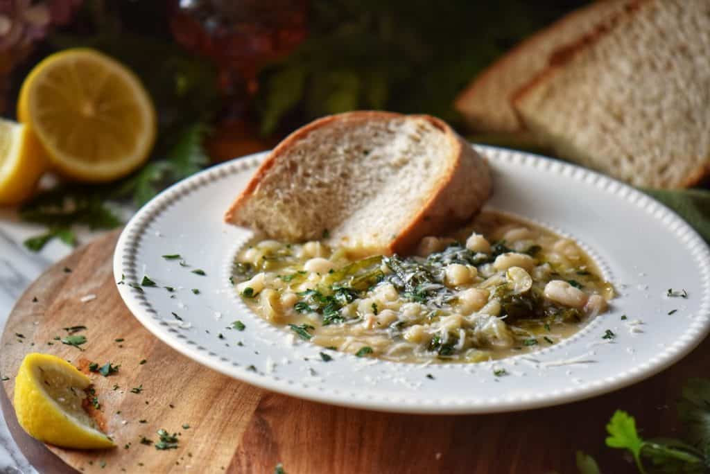 escaroel and beans served with a slice of whole wheat bread