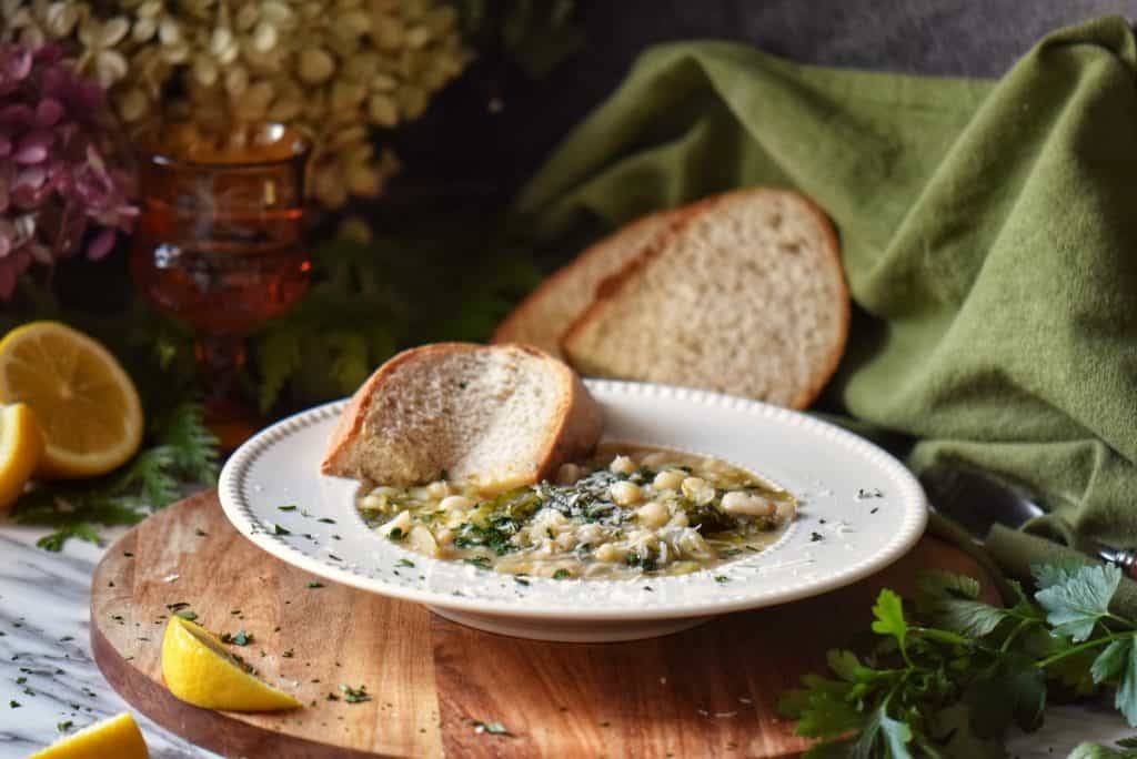 Beans and greens in a white bowl.