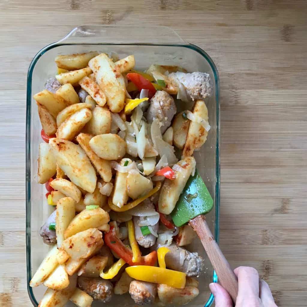 The ingredients used to make this Italian dish are being combined in a baking dish. 