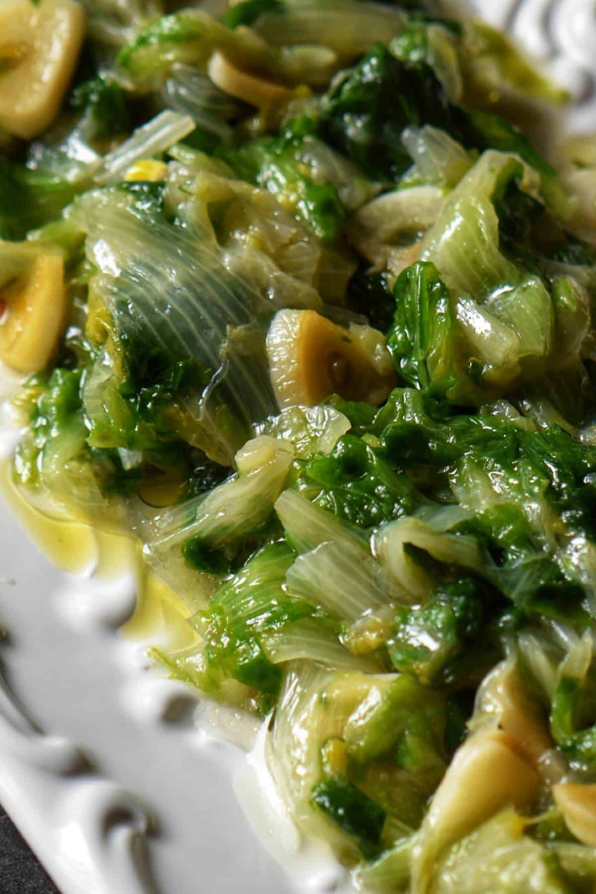 Sauteed Escarole on a white serving dish.