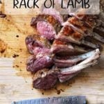 A rack of lambs on a wooden board.