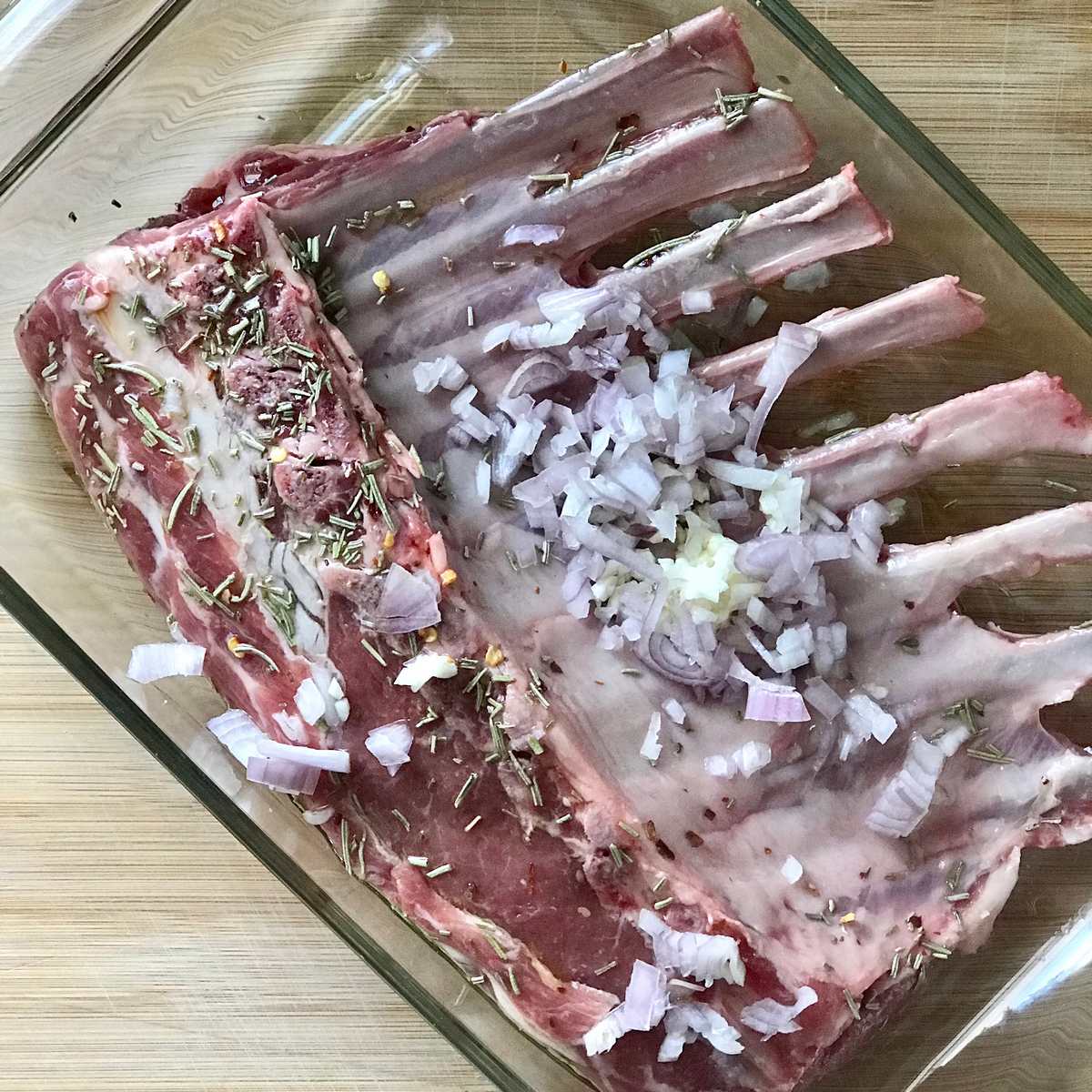 A rack of lamb in a baking dish. 
