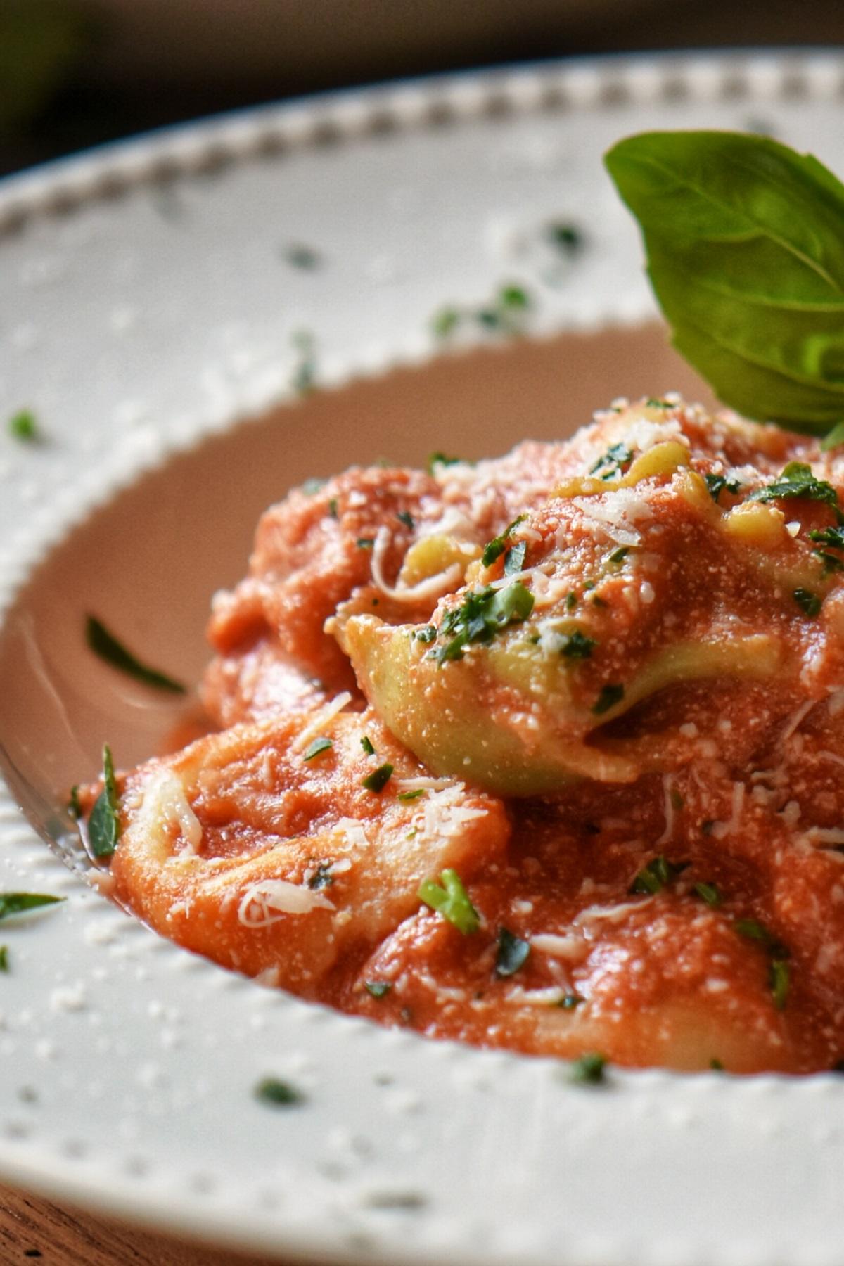 Tortellini with Creamy Tomato Sauce in a white dish.