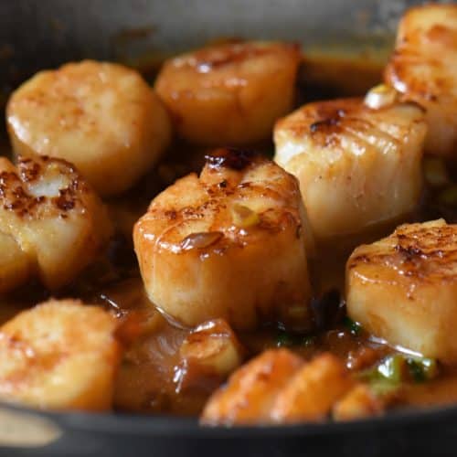 Pan seared scallops basted with the white wine sauce.