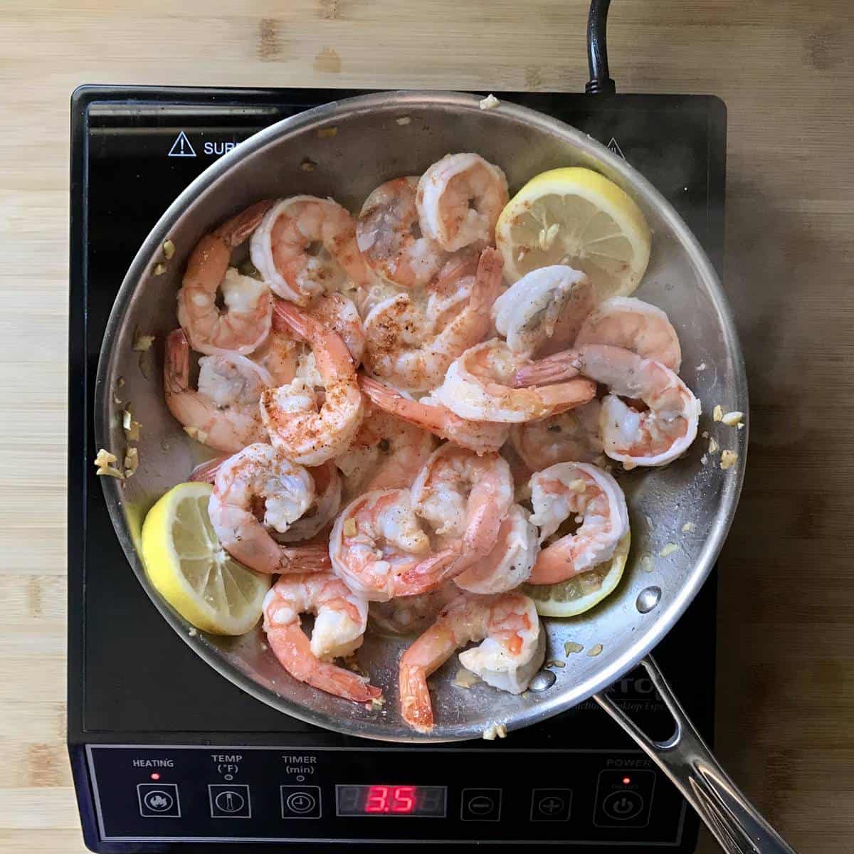 Shrimp being sauteed in a pan.