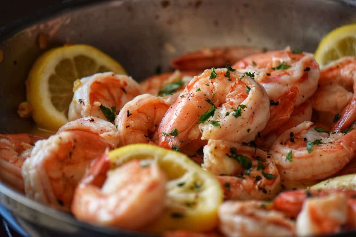 Shrimp in the process of being sauteed in a lemon wine sauce..