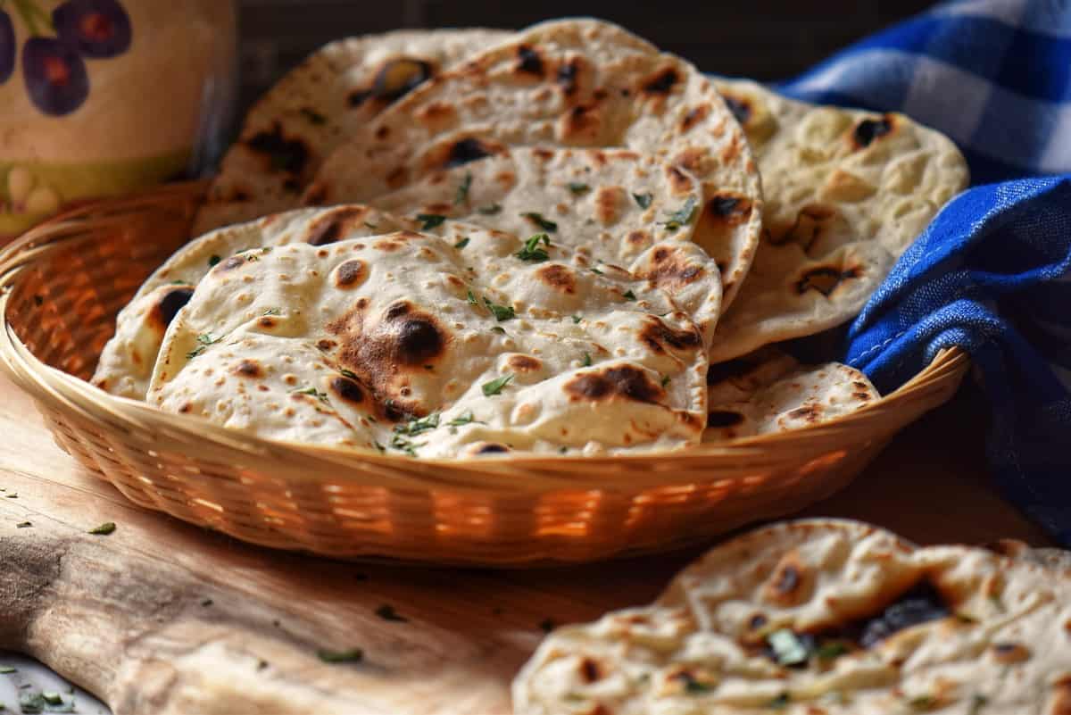 A stack of quick flatbread in a wicker basket.