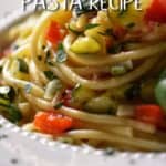 A Spaghetti Pasta Recipe with veggies in a while bowl.