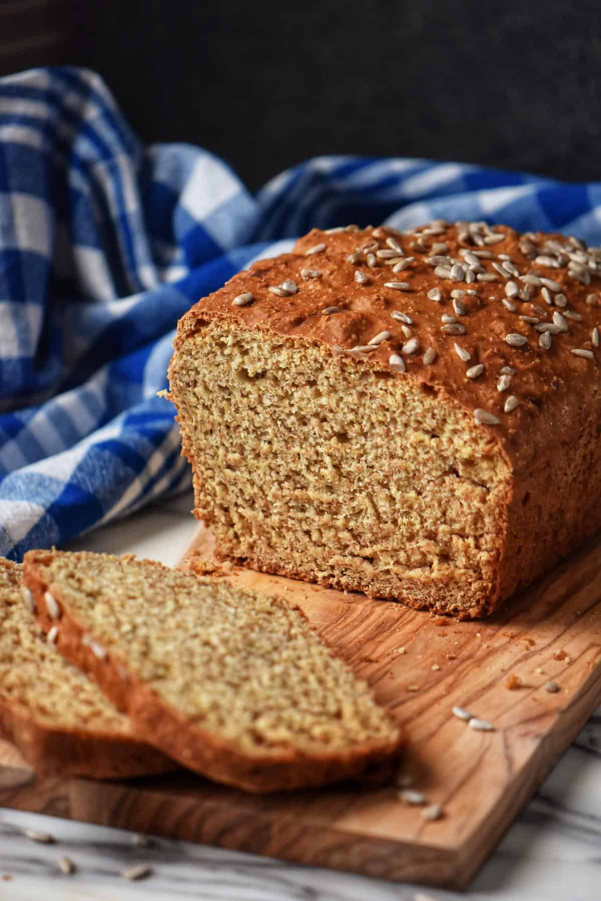 Sliced whole wheat bread on a wooden board.