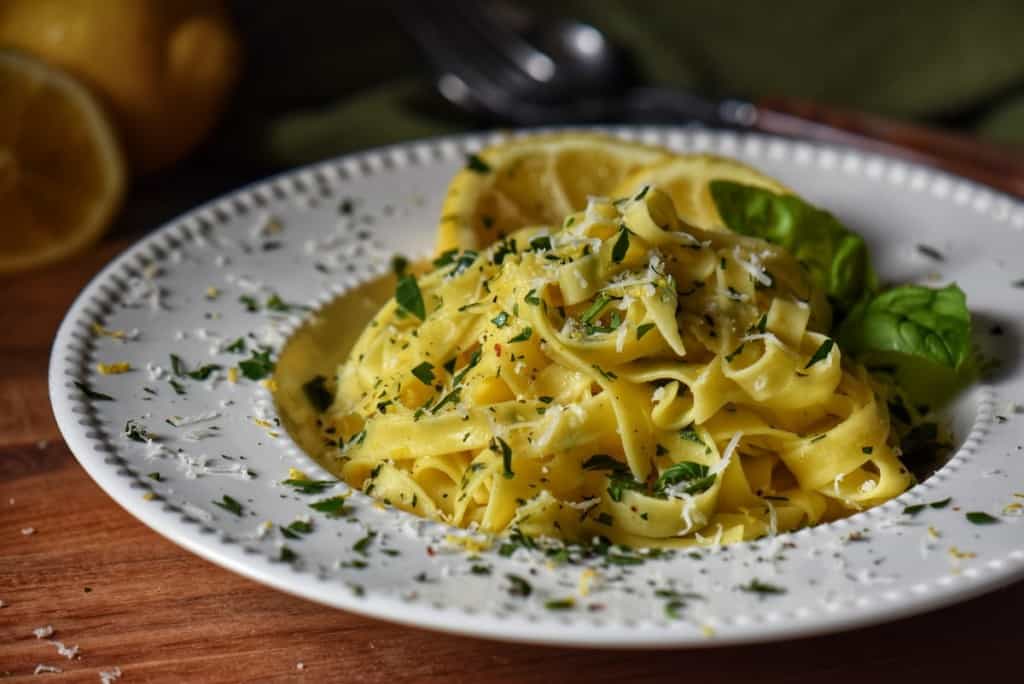 Lemon pasta garnished with grated cheese, fresh parsley and lemon zest.