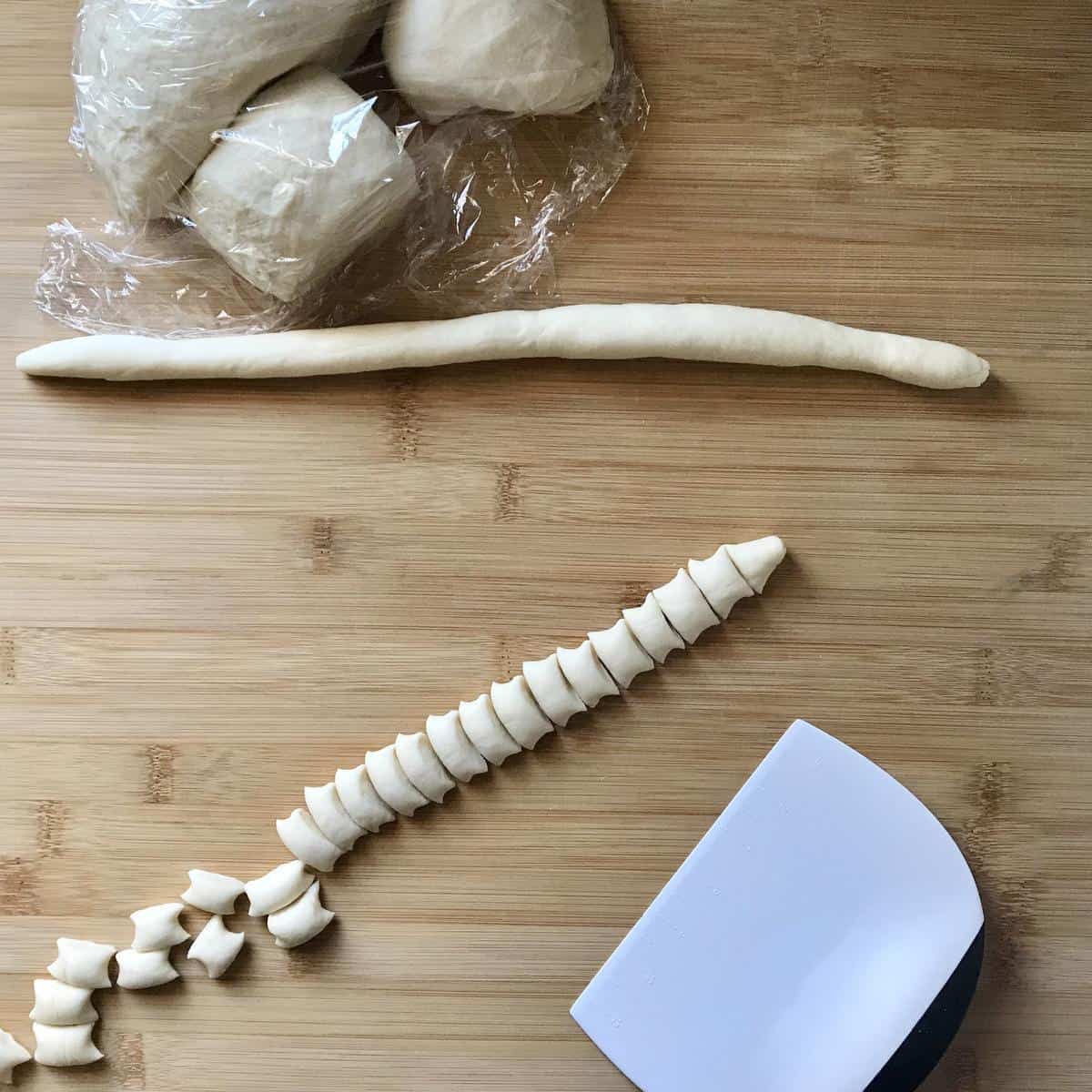 Ropes of cavatelli dough cut into small pieces.
