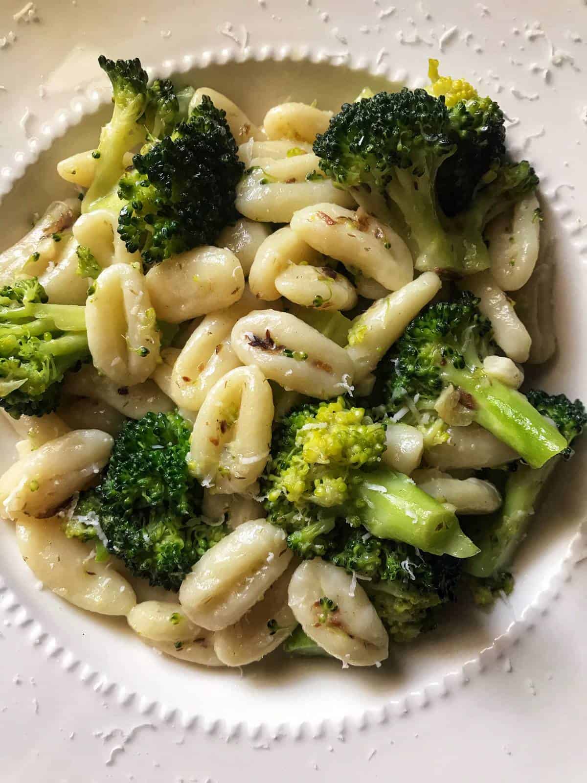 Cavatelli and broccoli in a white dinner plate.