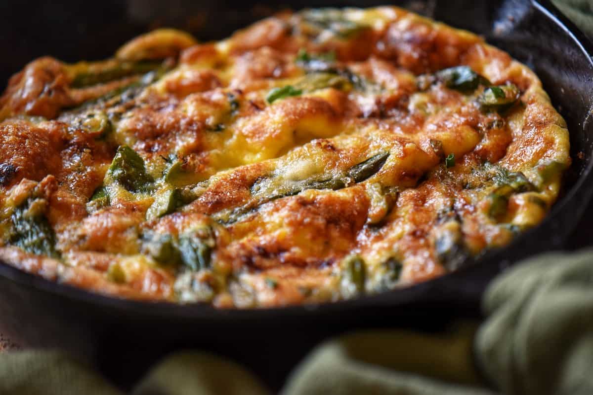 A close up of a freshly made Italian frittata recipe in a skillet.