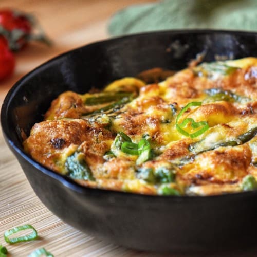 Asparagus Frittata in a dark pan.