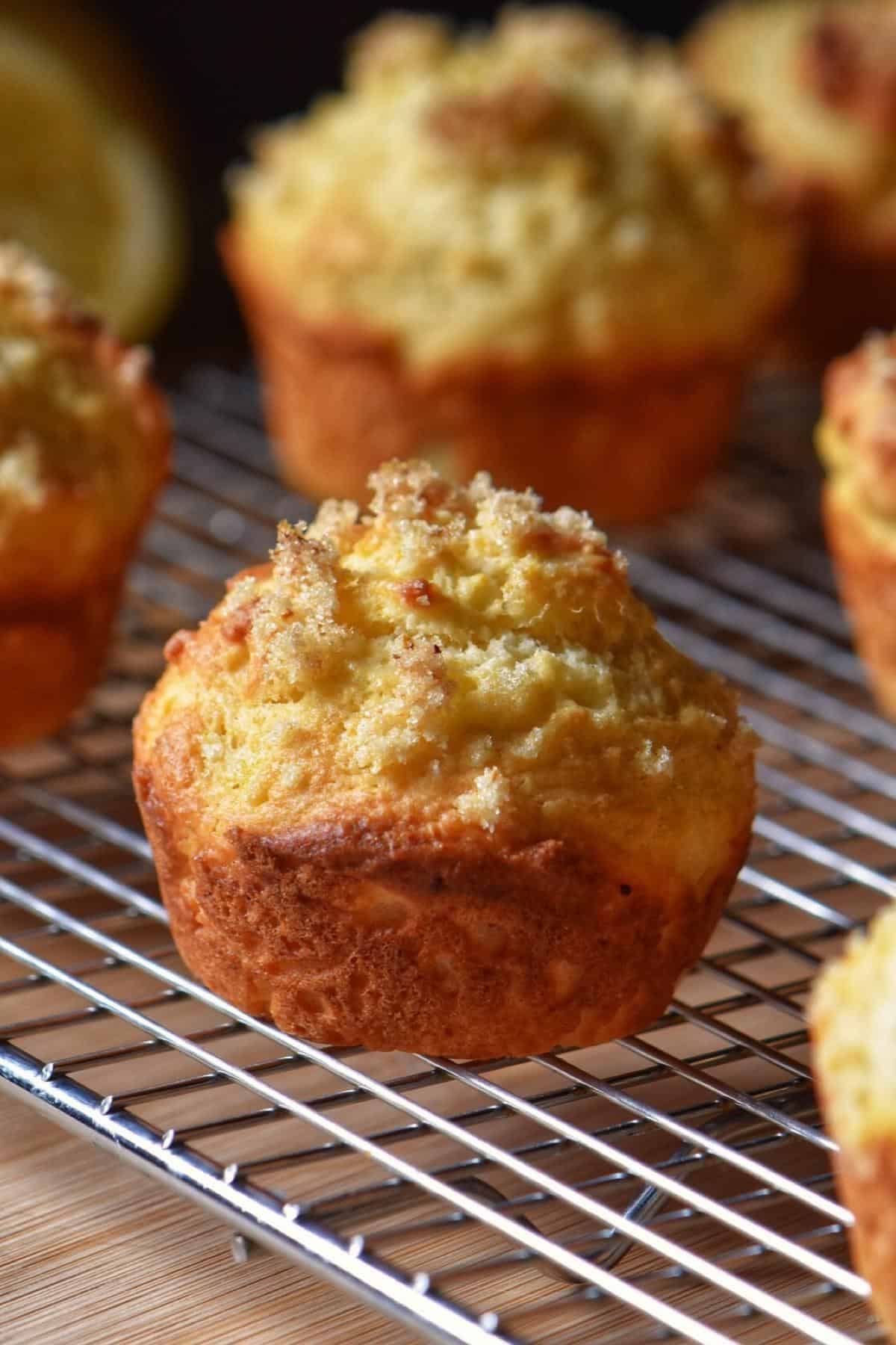 Lemon Ricotta Muffins cooling off on a wire rack.