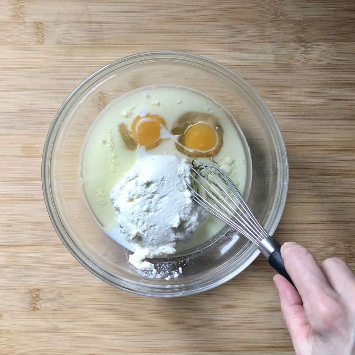 The wet ingredients are whisked together in a bowl.