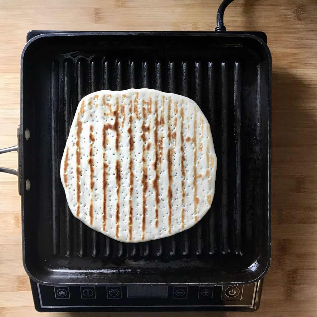 An Italian flatbread in a griddle pan.
