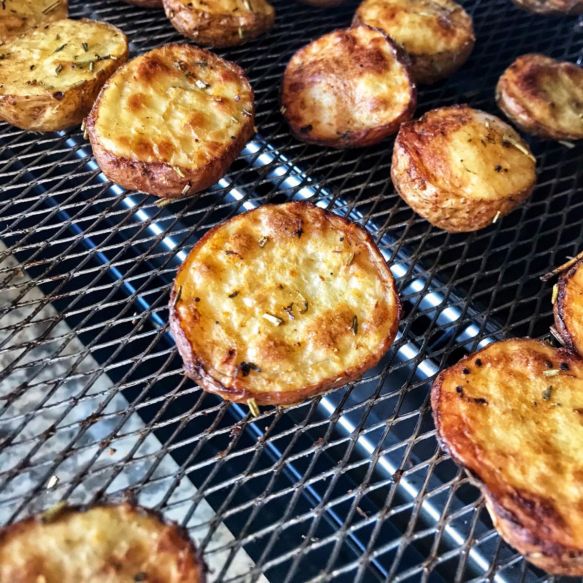 Roasted creamer potatoes on an air fryer basket.