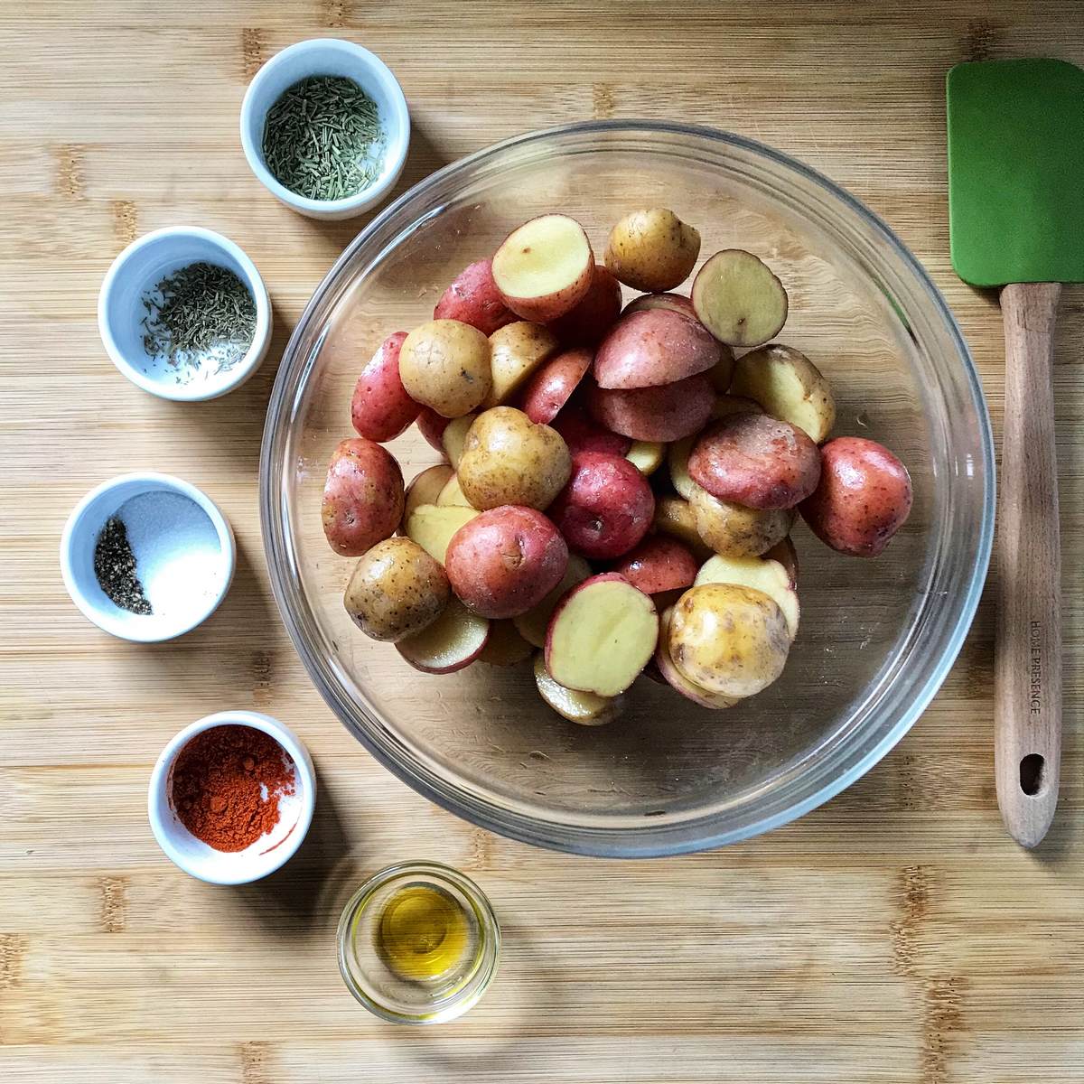 Ingredients to make the air fryer creamer potatoes are in bowls. 