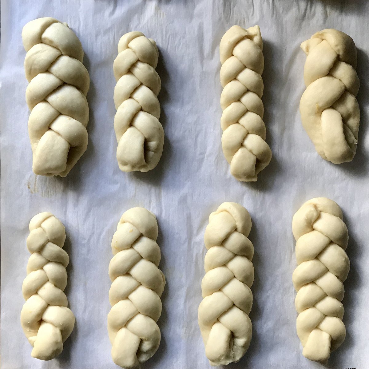 Braided sweet dough on a parchment lined cookie sheet.