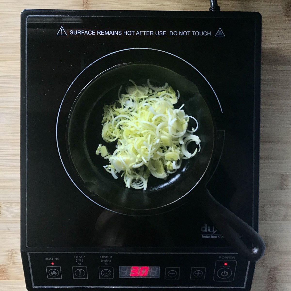 Sauteed leeks in a cast-iron pan.