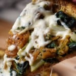 A healthy homemade pizza topped with Swiss chard and mozzarella.