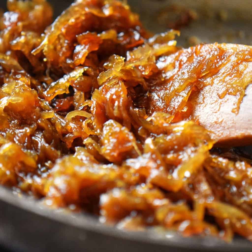 Golden brown caramelized onions in a pan.