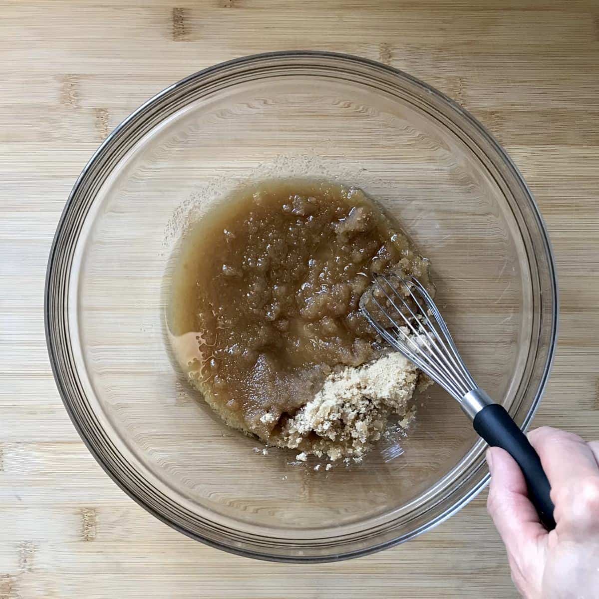 Brown sugar and oil whisked in a bowl.