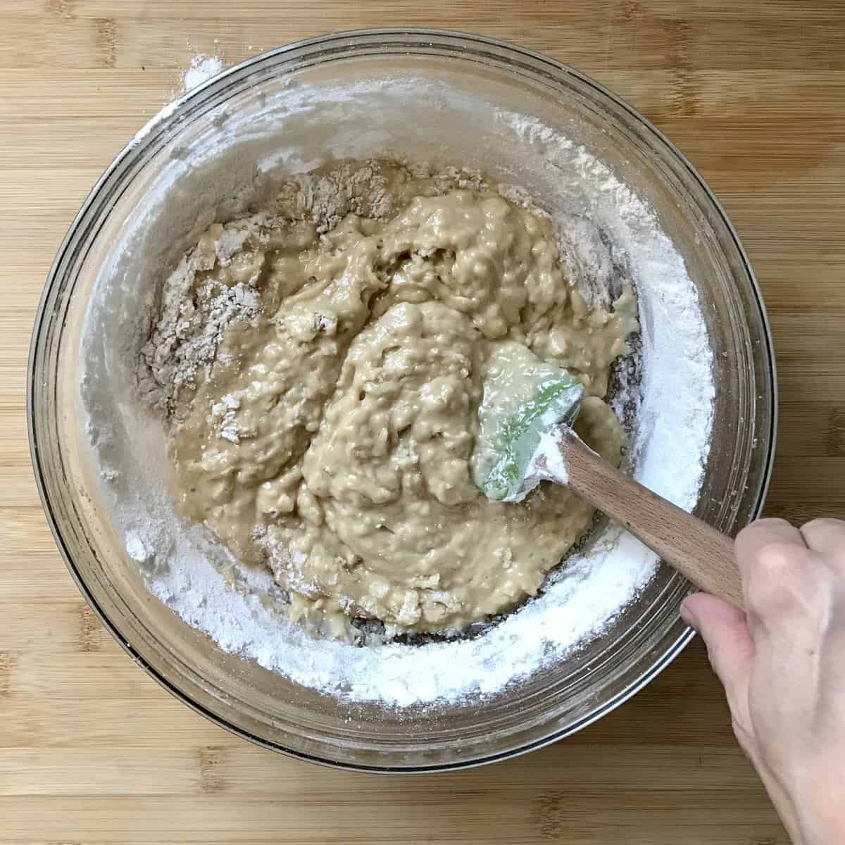 The wet and dry ingredients are combined together in a bowl. 